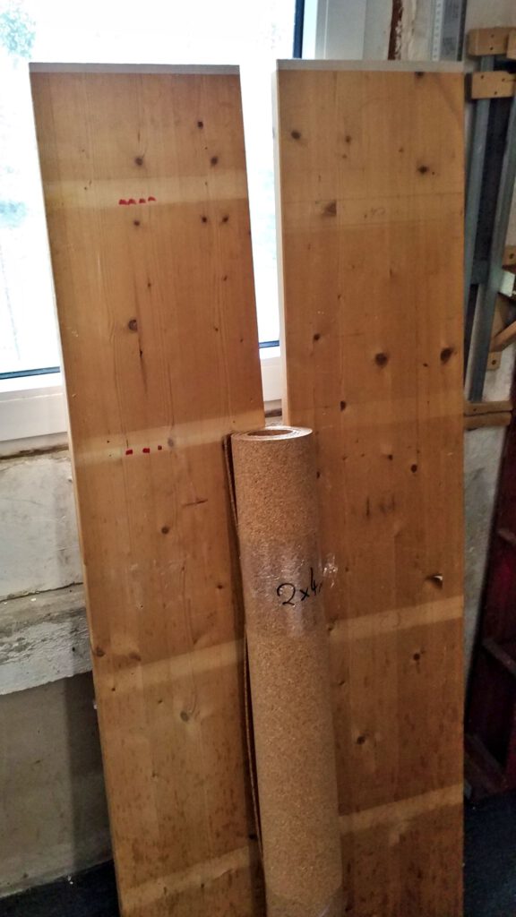 First off, the old shelve boards are cut to length and sanded. In the foreground, the cork mat.